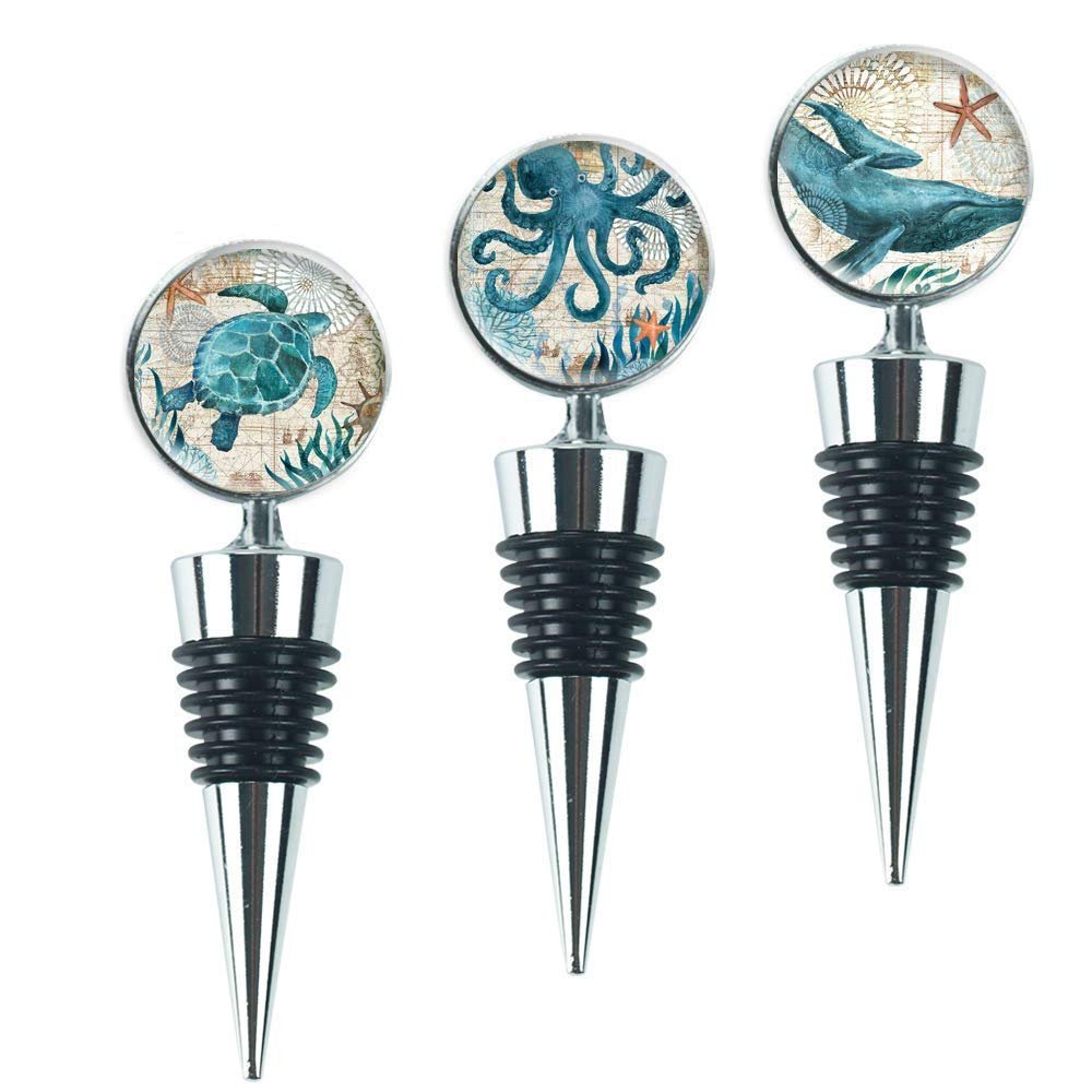 Three wine bottle stoppers with sea creature designs: turtle, octopus, and whale