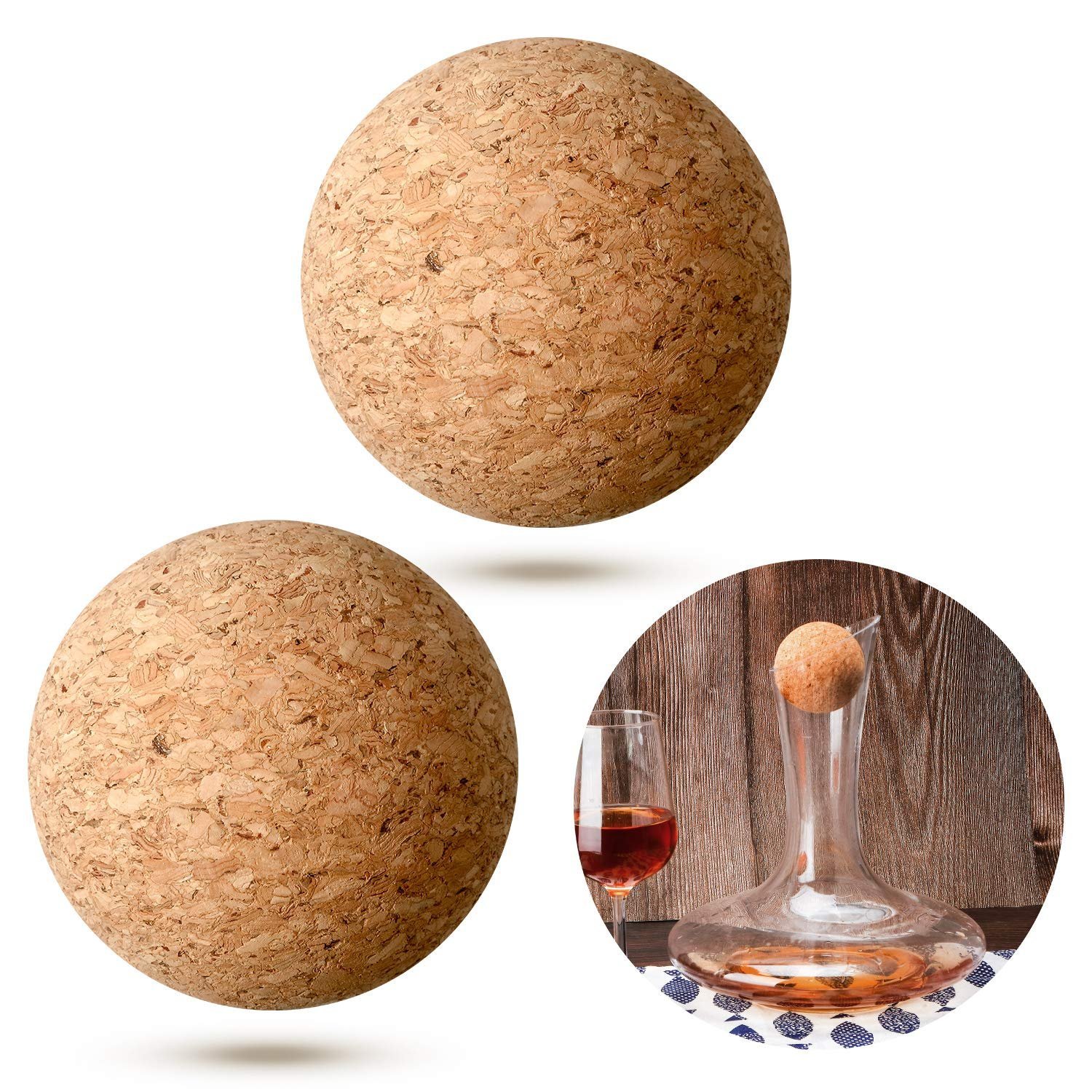 Three cork spheres, wine decanter with cork, and a glass of wine