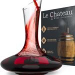 Wine being poured into a Le Chateau decanter with product packaging